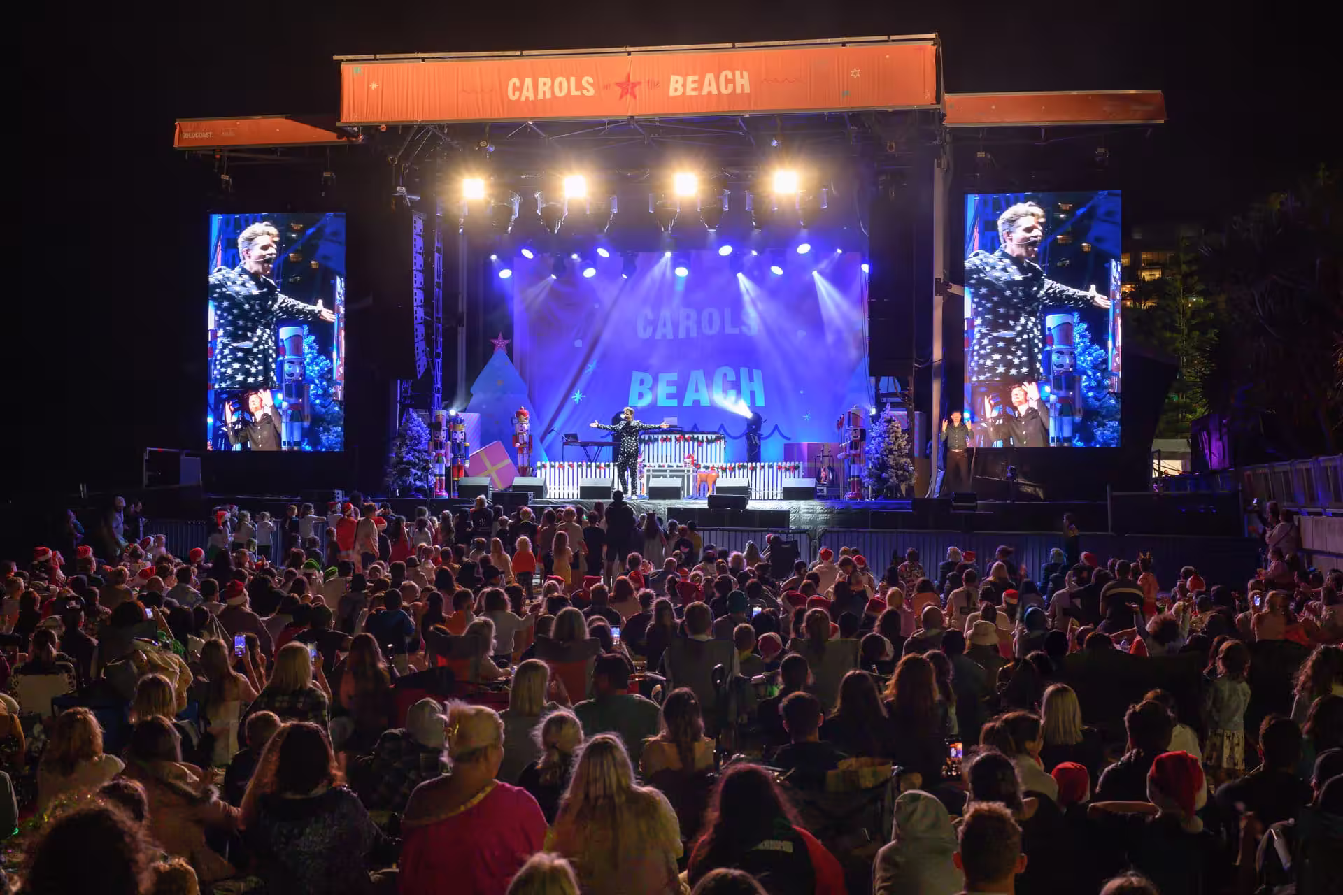 Outdoor concert crowd at a coastal event venue