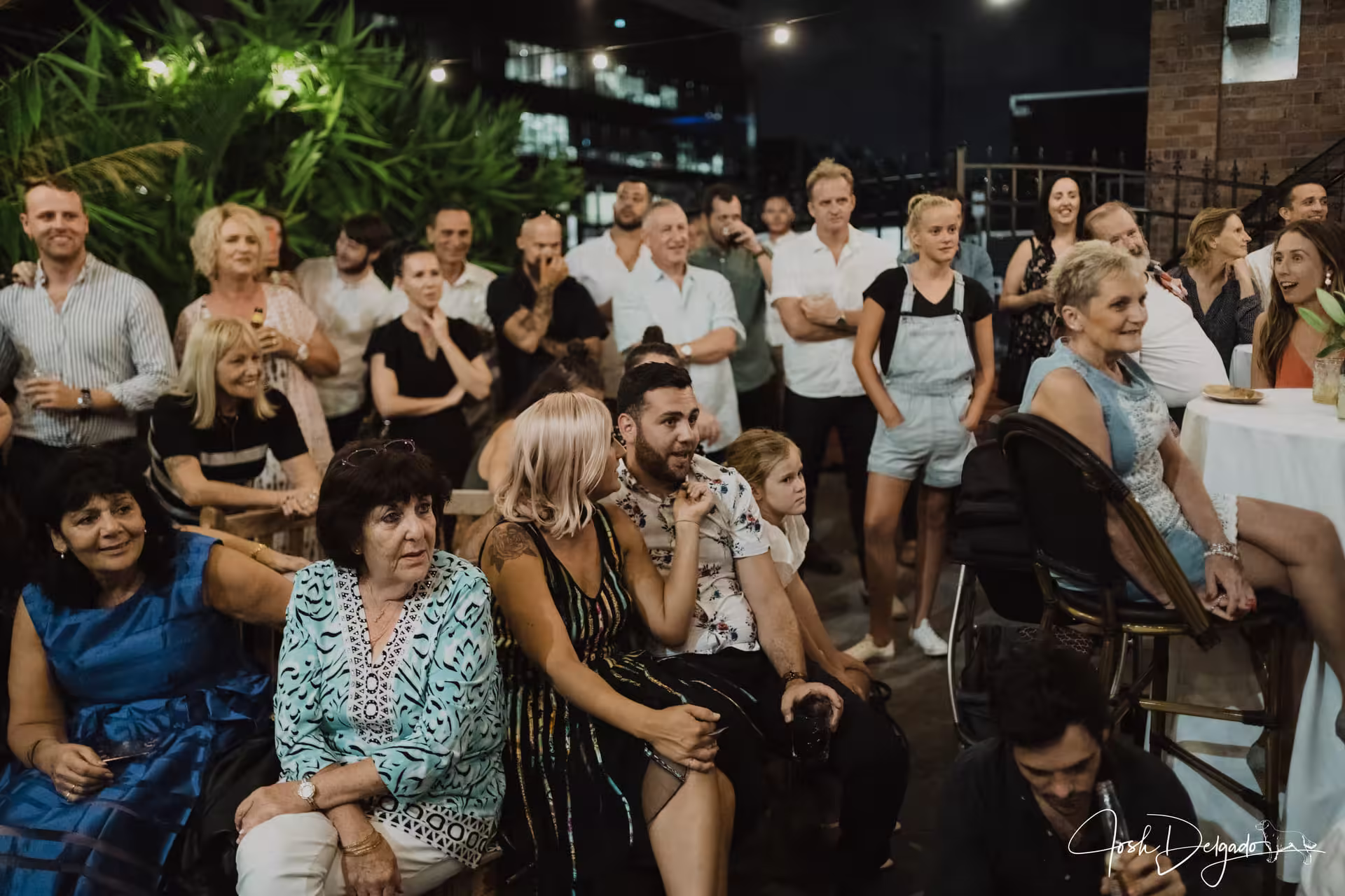 Guests gathered together enjoying live interactive magic