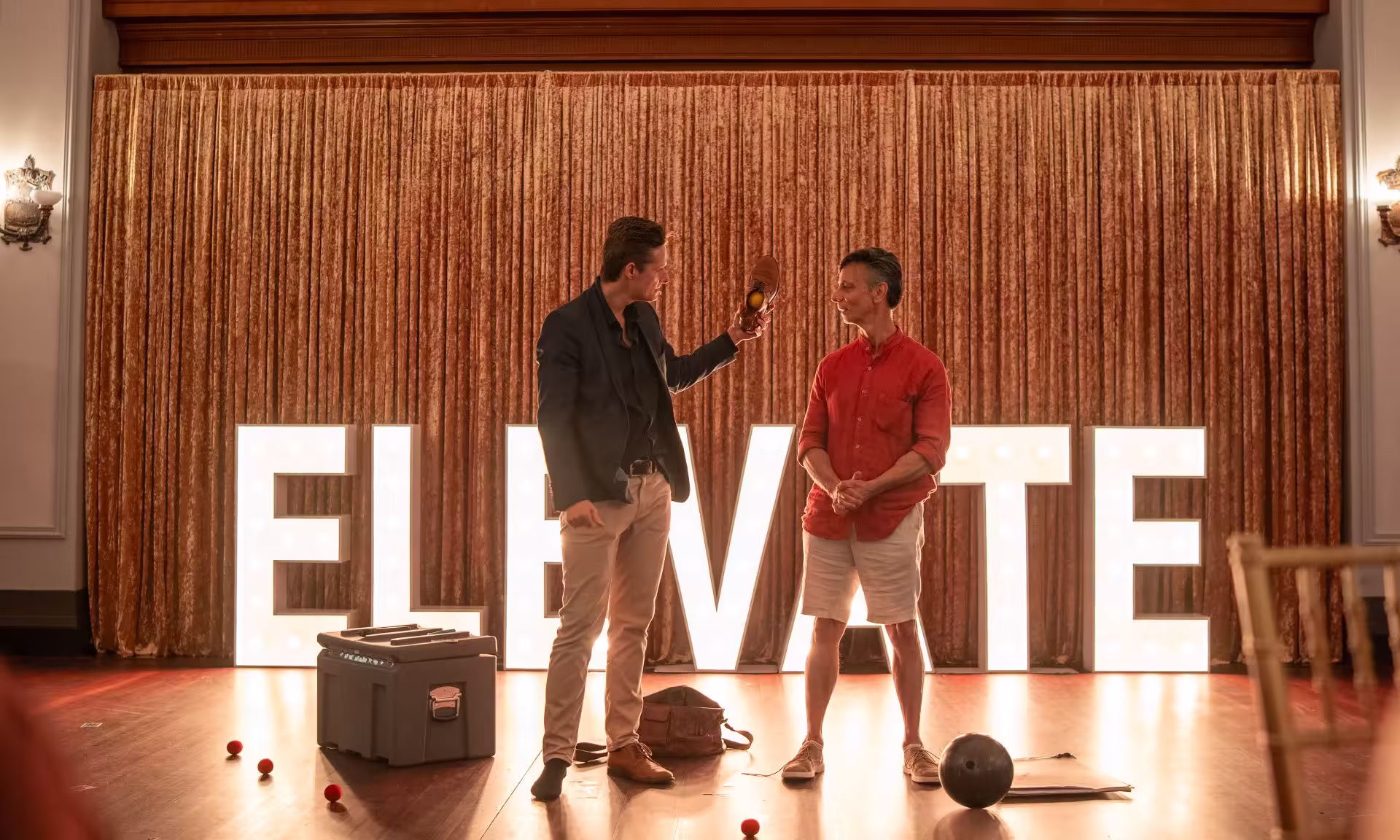 Jason Gray performing an interactive stage moment with a guest at a bucks party